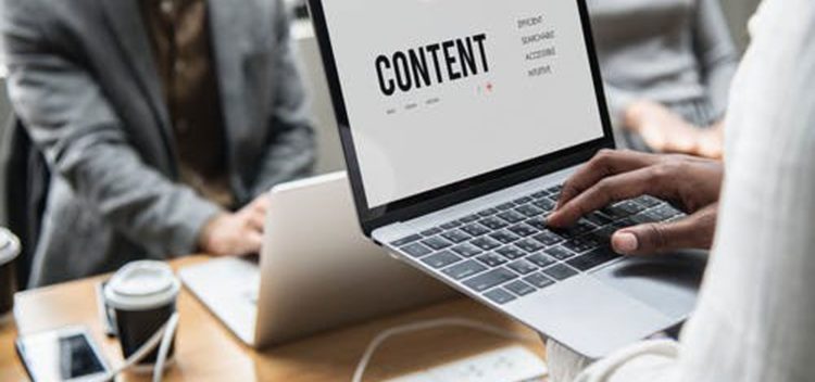 Person typing on computer with word content
